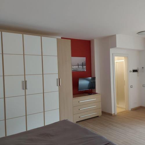 a bedroom with a bed and a television on a dresser at Villa Treccani Apartments in Malcesine