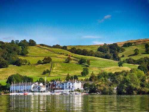 a house on a hill next to a body of water at Rayside in Penrith