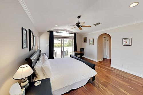 a bedroom with a white bed and a ceiling fan at Pierpont Coastal Dreams in Ventura
