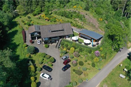 an aerial view of a building with cars parked in a parking lot at Haus Petra in Stadtkyll