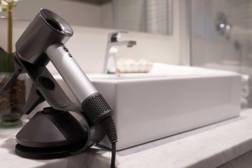 a hair dryer sitting on a counter next to a sink at F53 Kevin's Charming Houses in Alghero