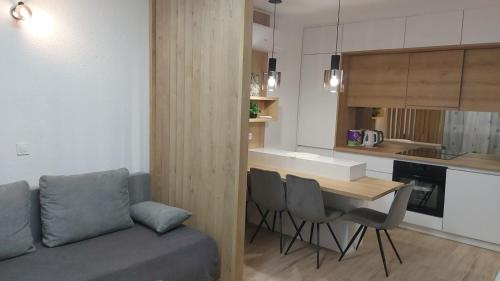 a living room and kitchen with a couch and a table at Central Apartment Bella in Split