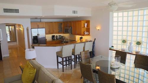 a kitchen and living room with a couch and a table at Villa Renaissance Grace Bay in The Bight Settlements