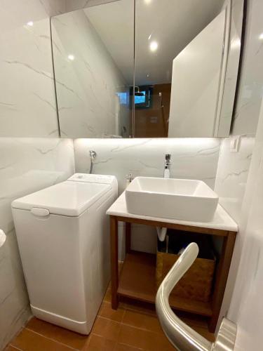 a white bathroom with a sink and a toilet at Villa Elea in Vourvourou
