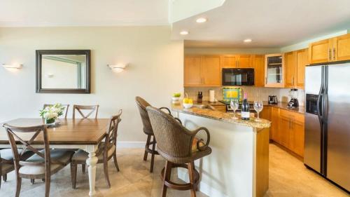 a kitchen with a table and a dining room at Villa Renaissance Grace Bay in The Bight Settlements