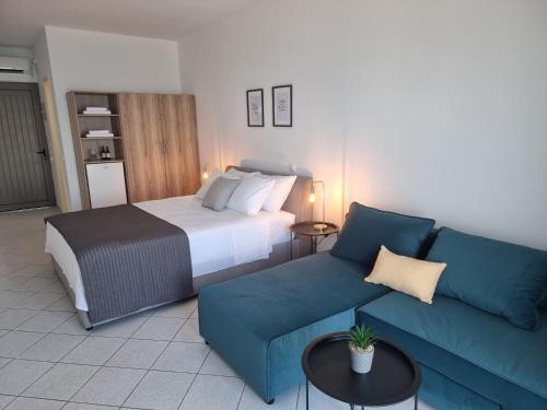 a hotel room with a bed and a couch at Thalasea in Mitikas