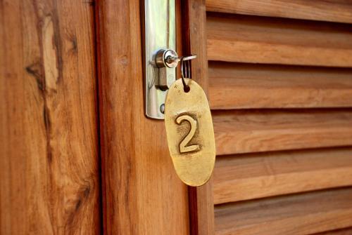 a wooden door with a lock with the number two at Auberge de la Table in Toliara