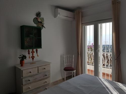 a bedroom with a bed and a dresser and a window at La Trufa - modern, spacious home in Moraira with panoramic sea views in Moraira