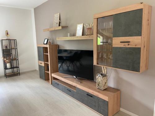 a wooden entertainment center with a tv on a wall at Ferienwohnung Burgzauber in Kastellaun