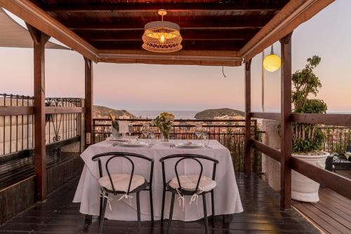 a dining room table with chairs and umbrellas at Ramada Resort by Wyndham Puerto de Mazarron in Puerto de Mazarrón