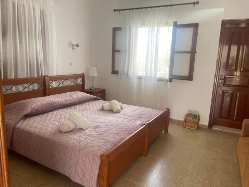 a bedroom with a bed with two towels on it at Aegean Endless Summer Villa Pefkos in Pefki Rhodes