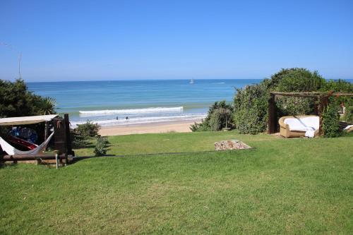 a view of a beach with a gazebo and the ocean at Vivir en la playa in Roche