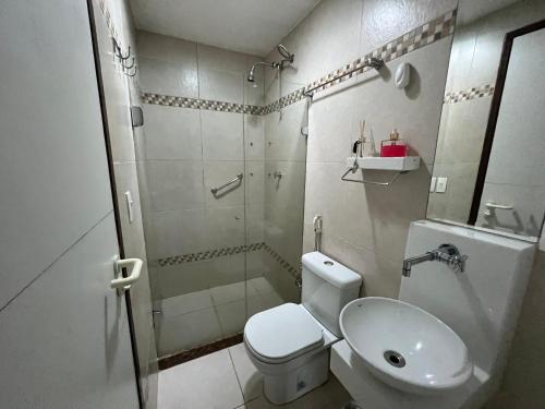 a bathroom with a shower and a toilet and a sink at Flat 301 Villa Hipica Resort - Gravatá, PE in Gravatá