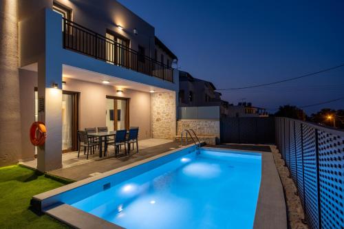 uma villa com piscina à noite em Anna's Residence with Private Pool em Atsipopoulo