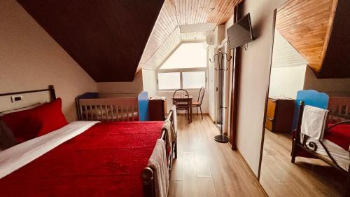 a bedroom with two beds in a room with a window at Hotel Drinos in Tirana