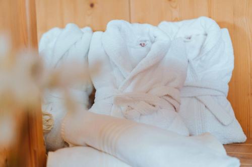 a pile of white towels sitting on a shelf at Wanderhotel Teiserhof in Funes