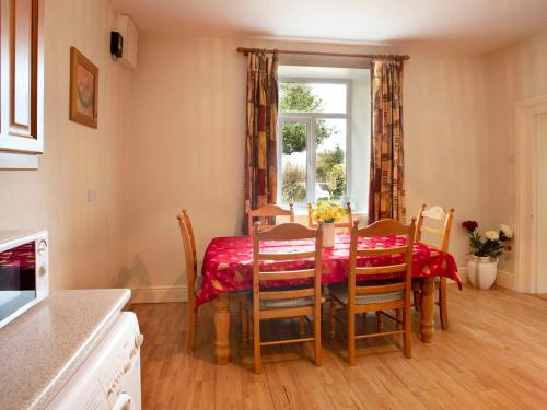 a kitchen with a table and chairs and a window at Glen Gable in Fethard on Sea