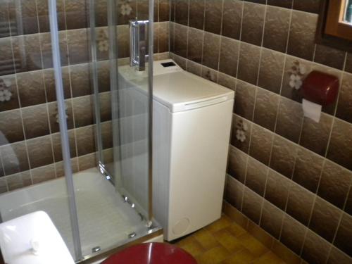 a bathroom with a toilet with a glass shower at a l'orée de tronçais in La Perche