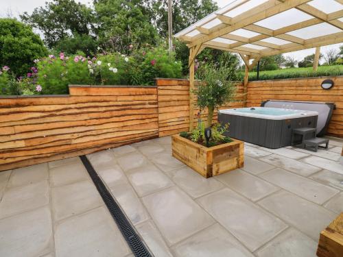 a backyard with a wooden fence and a hot tub at Brynawel in Carmarthen