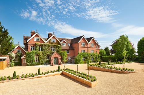 a large house with a garden in front of it at The Riverside in Salisbury