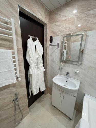 a bathroom with a sink and a mirror at Anga Yerevan Hotel in Yerevan