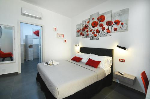 a bedroom with a large bed with red pillows at Elis b&b Villasimius in Villasimius