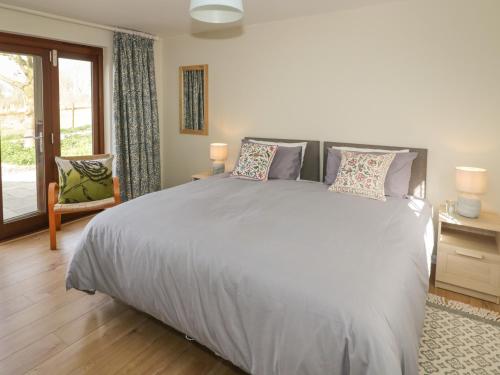 a bedroom with a large bed and a window at The Wash House in Banbury