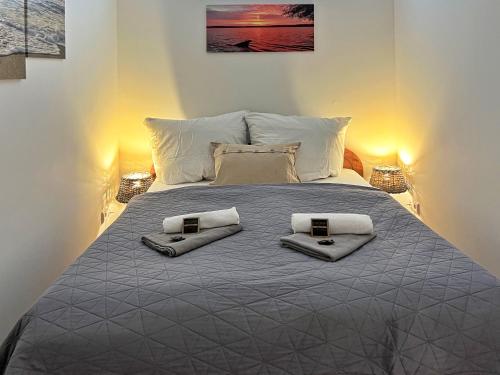 a bedroom with a large bed with towels on it at Landlust Hotel in Gransee