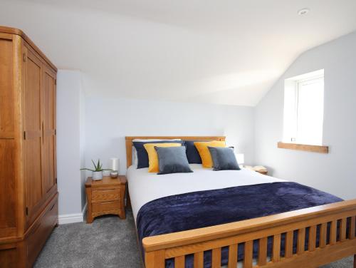 a bedroom with a large bed and a window at The Elberry in Llanfairpwllgwyngyll