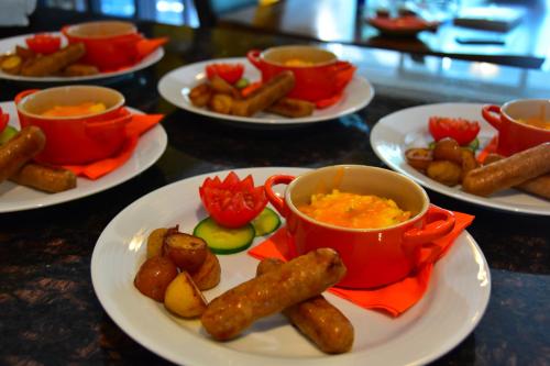 a table with plates of food and bowls of soup at Explorer House Bed & Breakfast in Niagara on the Lake