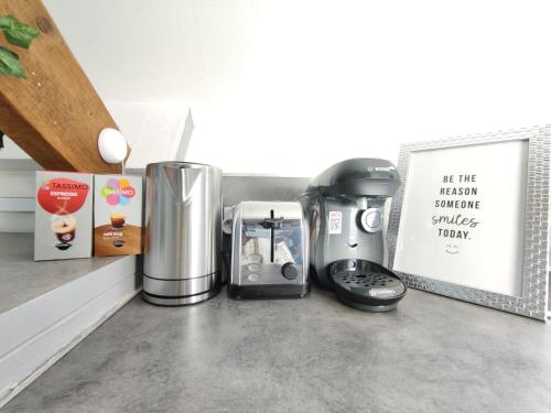 a kitchen counter with a coffee maker on a counter at Studio Hypercentre - Quartier Gare in Valenciennes