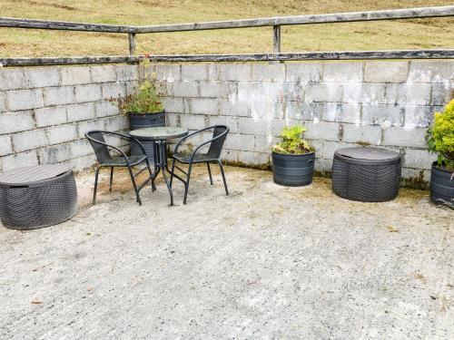 a table and chairs with pots of plants at Sarah Magees in Enniskillen