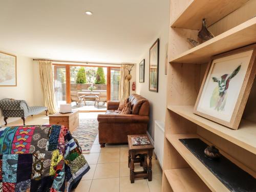 a room with a bed and a couch and a table at Loose Farm Lodge in Battle