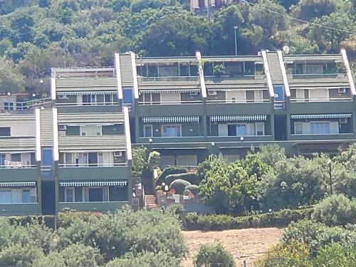 a large building with trees in front of it at Beach of Eden Cefalu' in Cefalù
