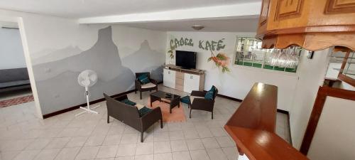 an overhead view of a living room with a table and chairs at Label kafé in Bouillante