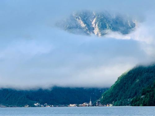a mountain in the middle of a body of water at Bergheimat in Bad Goisern