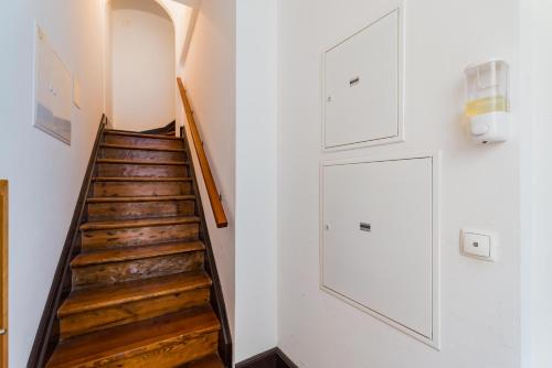 a staircase in a house with white walls and wooden floors at Historic Center 3 in Coimbra