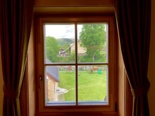 a window with a view of a yard at Apartmány Roháče in Zuberec