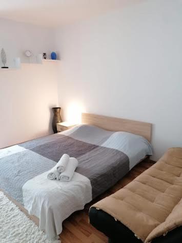 a bedroom with a bed with two towels on it at Nexus Studio Deluxe in Miercurea-Ciuc
