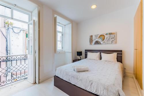 a bedroom with a large bed and a window at Historic Center 1 in Coimbra