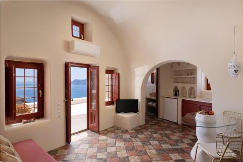 a living room with a view of the ocean at The Architect's Cave House in Oia