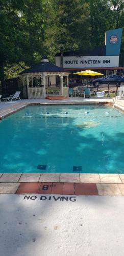 a large blue swimming pool in front of a building at Route 19 Inn in Maggie Valley