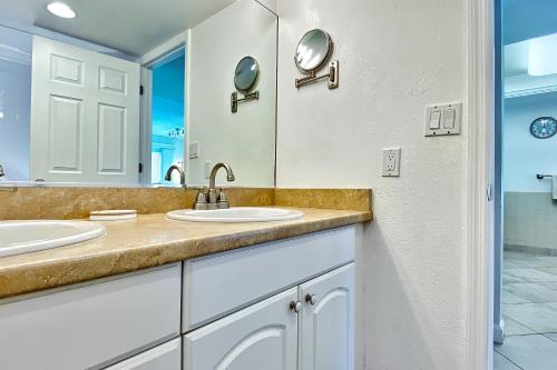 a bathroom with two sinks and a mirror at Holiday Villas III 703 in Clearwater Beach