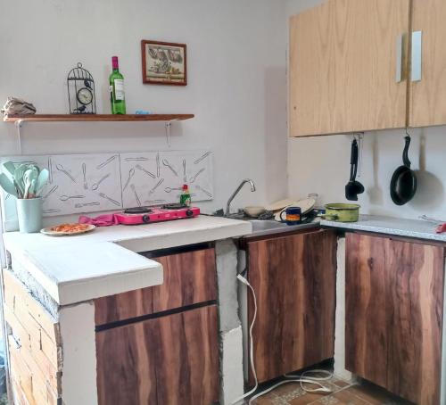 a kitchen with wooden cabinets and a counter top at El Costeñito Hostal in Veracruz