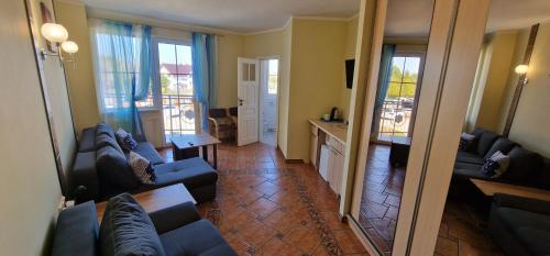 a living room with two couches and a table at Apartamenty Hexagon 7 in Grzybowo