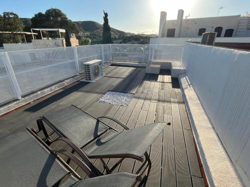 two chairs sitting on top of a roof at La Terraza de Agua Amarga in Agua Amarga