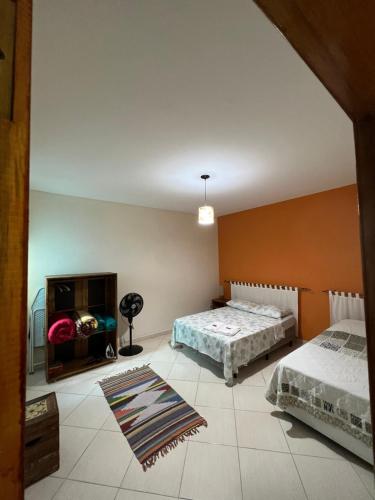 a bedroom with two beds and a fireplace at Apartamento Elite em Cunha in Cunha