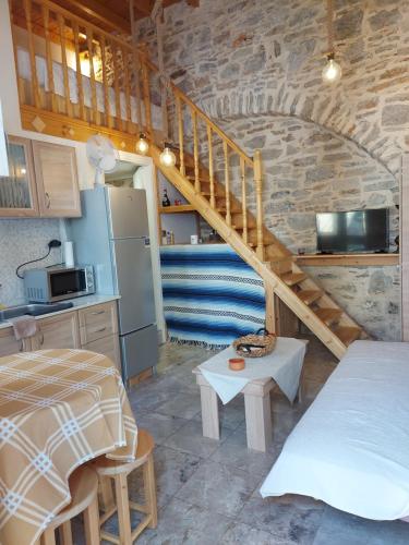 a kitchen with a staircase in a room at Ήλιος Πατσακης in Symi