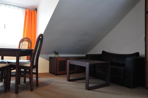 a living room with a couch and a table at Hostel Pestalozza in Špindlerův Mlýn