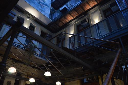 a staircase in a building with windows and a ceiling at Parla Hostel in Buenos Aires